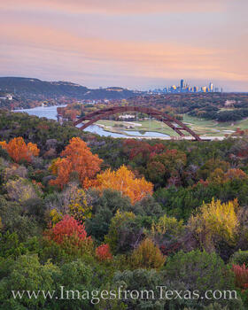 Fall colors of orange and red highlight this photograph of the 360 Bridge (Pennybacker Bridge) outside of Austin, Texas.