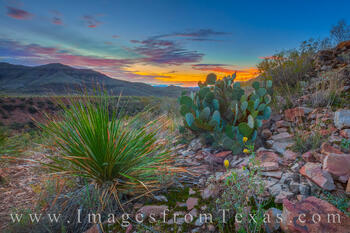 A colorful sunset lights up the sky on the western slope of the Chisos Mountains in Big Bend National Park.