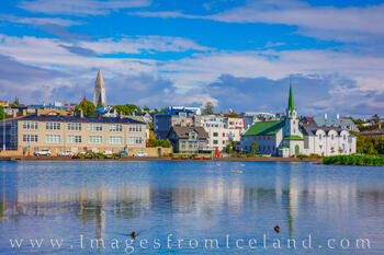The beautiful city of Reykjavik as seen from the shores of Tjörnin, one of its lakes.