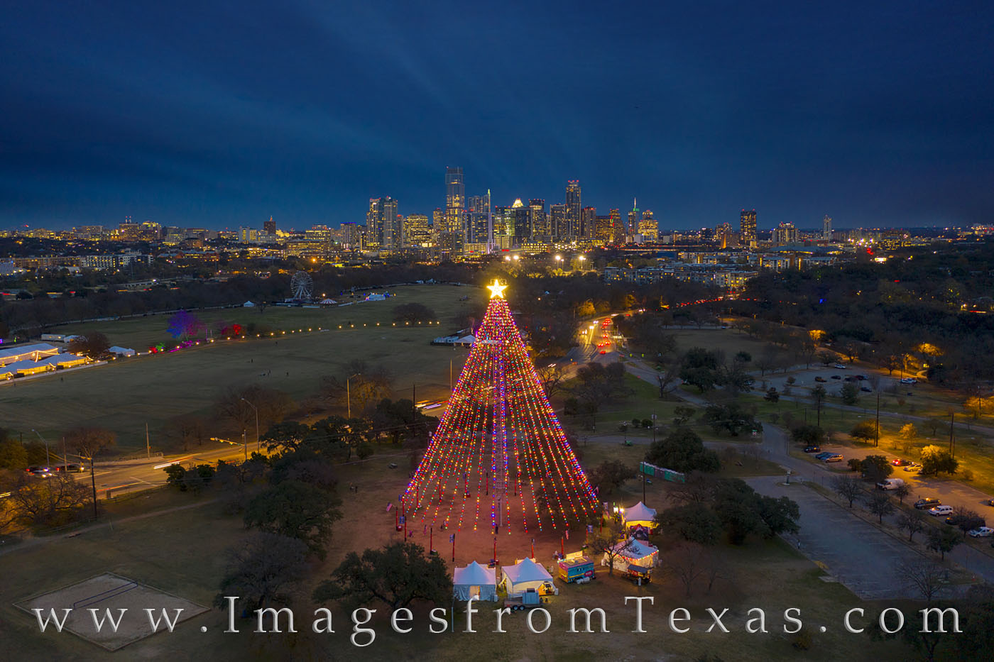 The Zilker Park Christmas Tree shines in the cool December night and the beautiful skyline of Austin lights up as night falls...