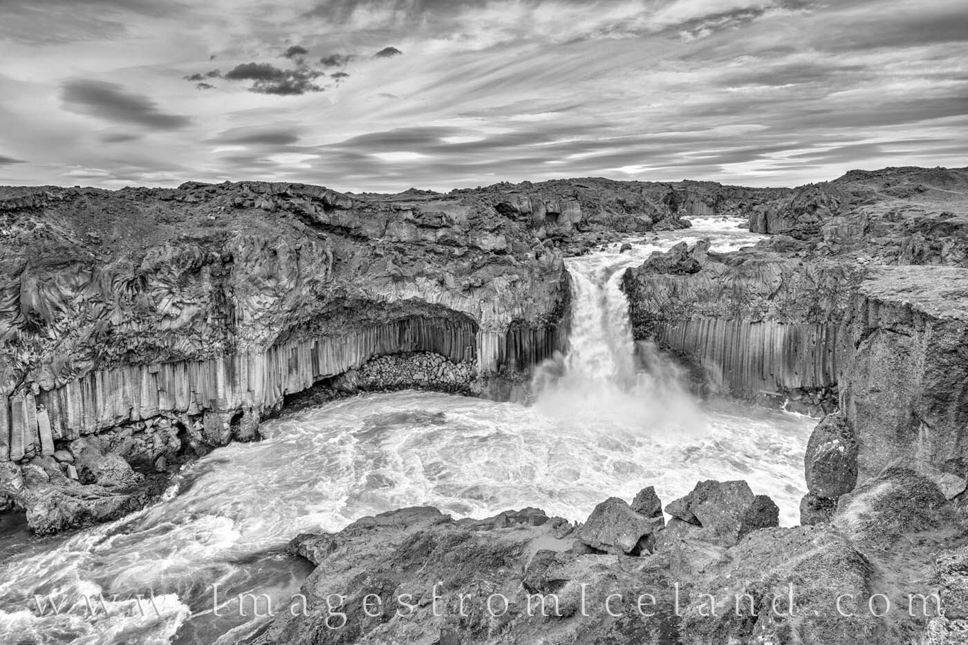The beautiful waterfall, Aldeyjarfoss, lined with hexagonal basalt columns, plummets downward in its march to the Arctic Sea...