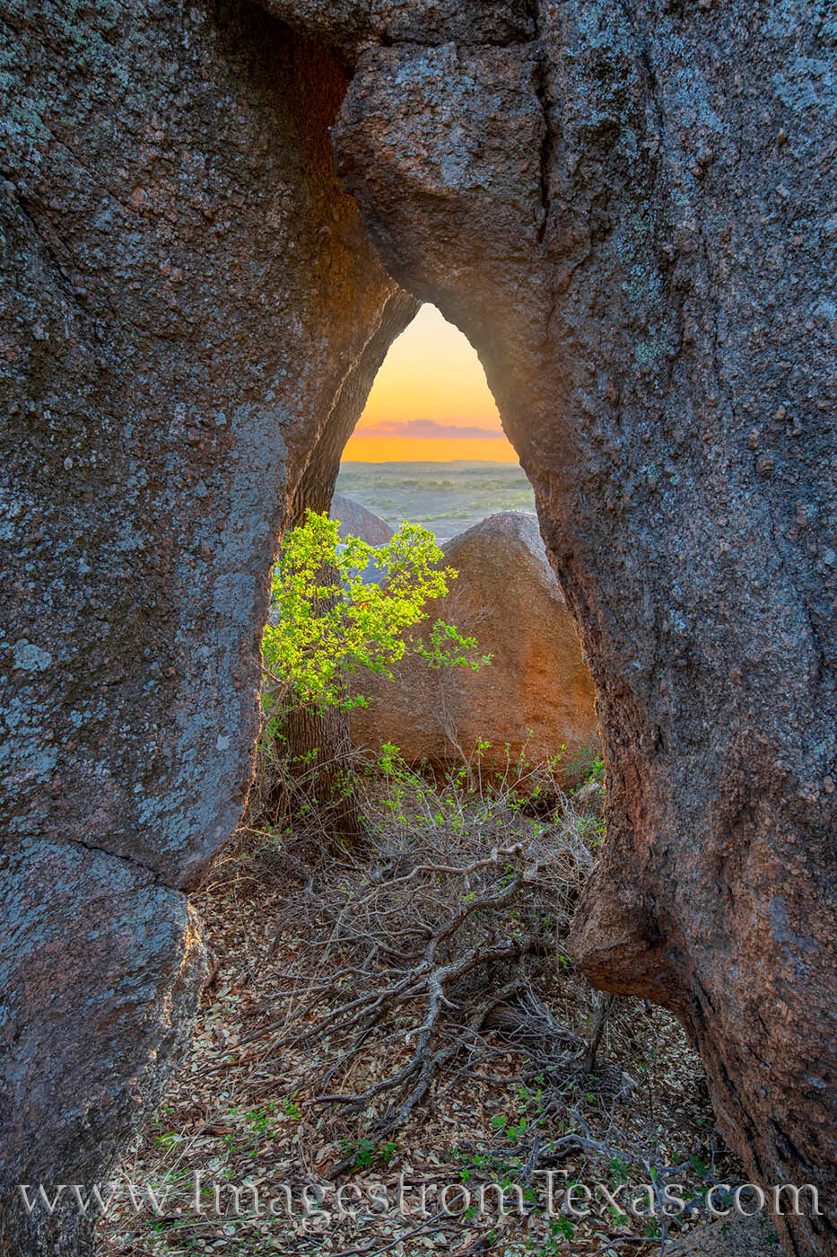 A small arch offers a window to the Hill Country at Enchanted Rock State Natural Area.