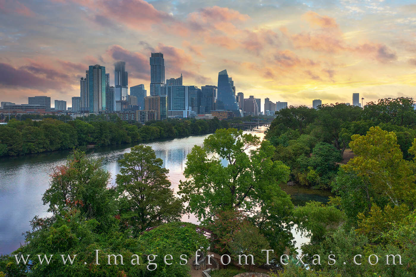 From just above the treetops, this aerial view shows Lady Bird Lake and the Austin skyline on a moody morning as low clouds raced...