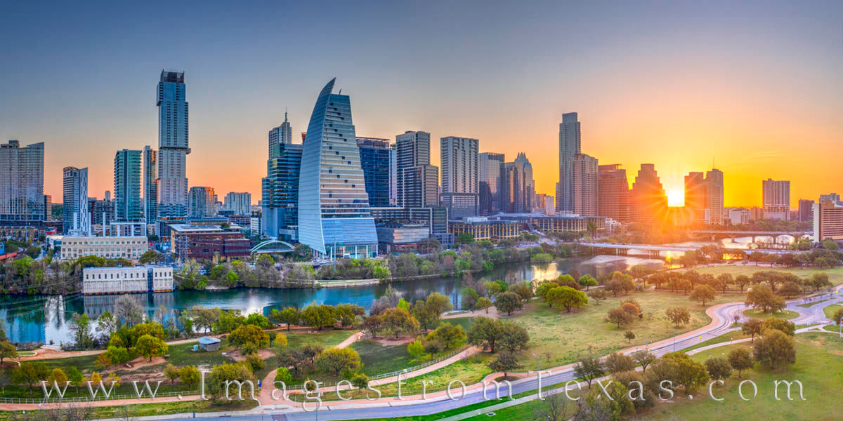 The sun's first light of day spreads across Lady Bird Lake and downtown Austin on a cool April morning in this aerial panorama...