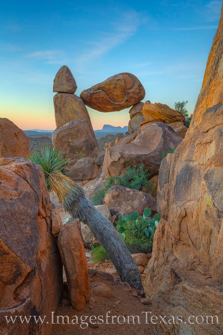 Through a few boulders, Balanced Rock comes into view. And through the opening there, distant mountains appear in the cold November...