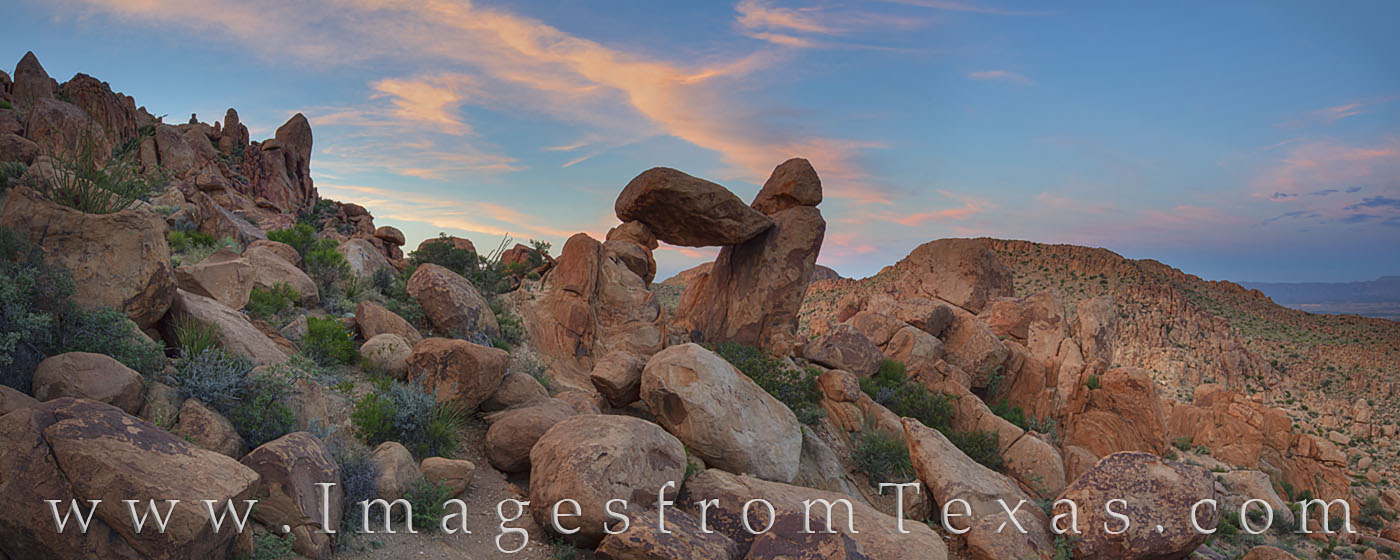 Looking northwest at the iconic Balanced Rock in Big Bend National Park, this panorama shows the varied landscape of rocks, yucca...