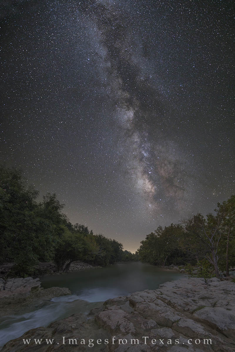 High over the Barton Creek Greenbelt, the Milky Way scrolls across the night sky. Unfortunately we can’t actually see the night...
