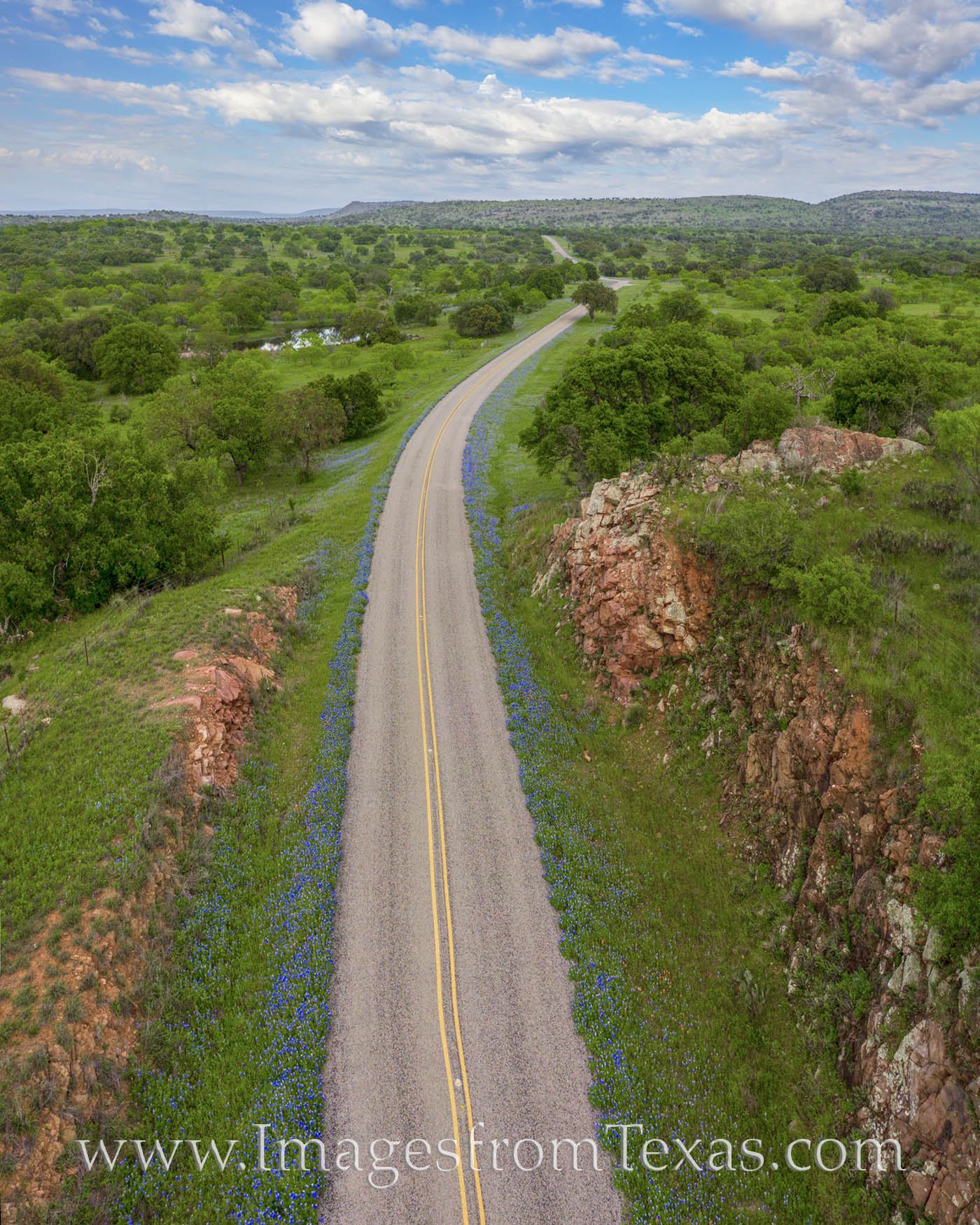 This beautiful aerial view of bluebonnets that line the road was taken with a drone on a perfect spring afternoon in the Texas...