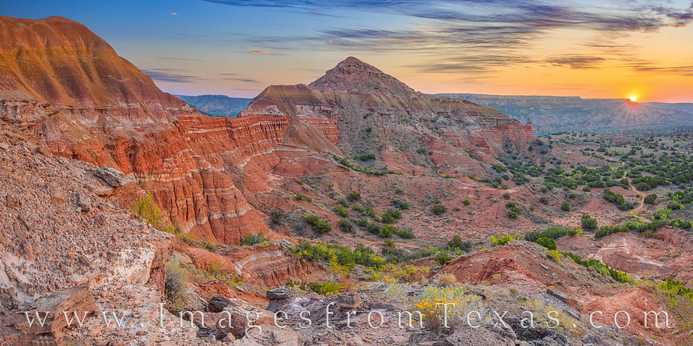 From a precariouis ledge to the west of the iconic Capitol Peak, this panorama shows off the colors of sunrise in Palo Duro Canyon...