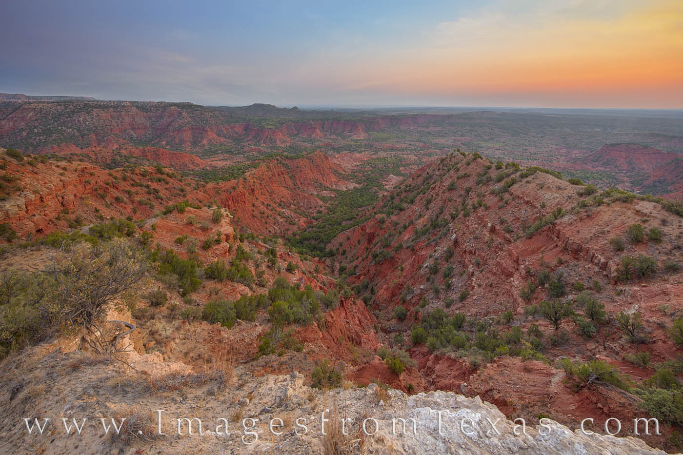 The red and orange of the Haynes Ridge Overlook seems to glow in the early morning light. Far below, the valley floor is 600...