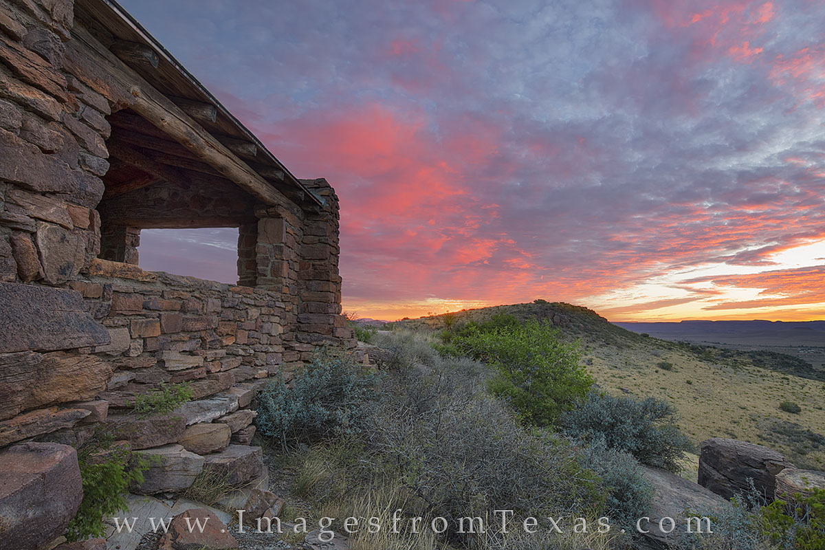 Well before sunrise, the clouds light up over the Davis Mountains and Fort Davis. This old stone shelter was built by the CCC...