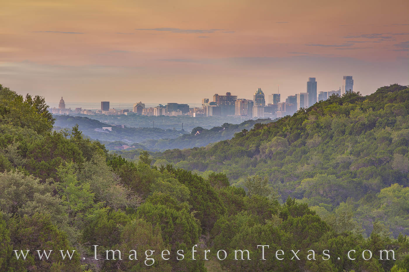 The high rises of downtown Austin are seen here in the warm morning light of a summer day. Taken from several miles away with...