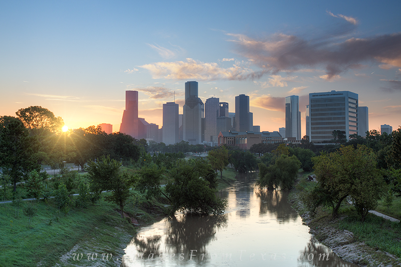 From a pedestrian bridge that crosses Memorial Parkway, I caught this image of the sun peeking over downtown Houston and lighting...