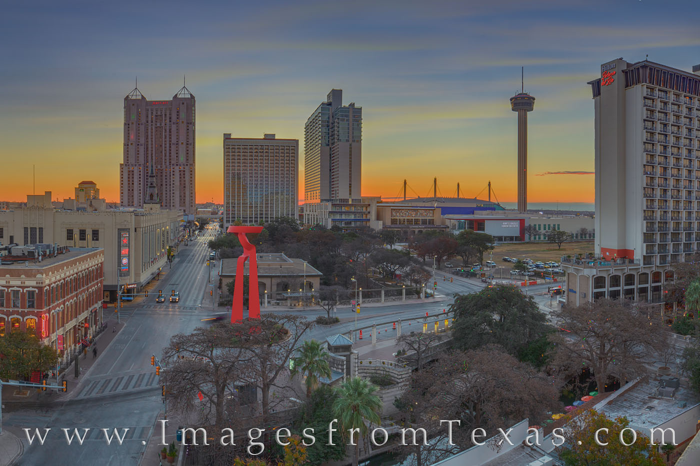 The iconic Tower of the Americas rises into the cool morning air just before sunrise in downtown San Antonio. In the foreground...