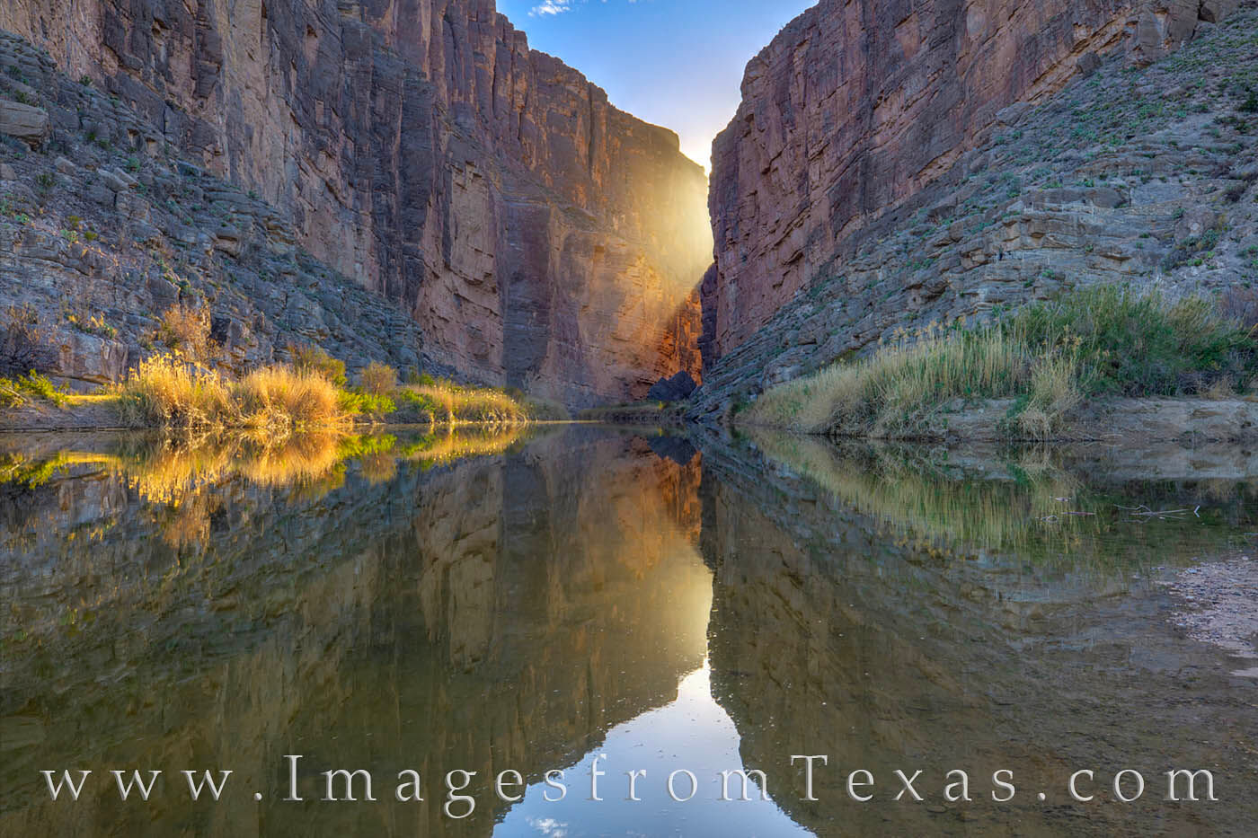 The last rays of sunshine peek through the steep canyon walls at Big Bend's iconic Santa Elena Canyon on a calm spring evening...