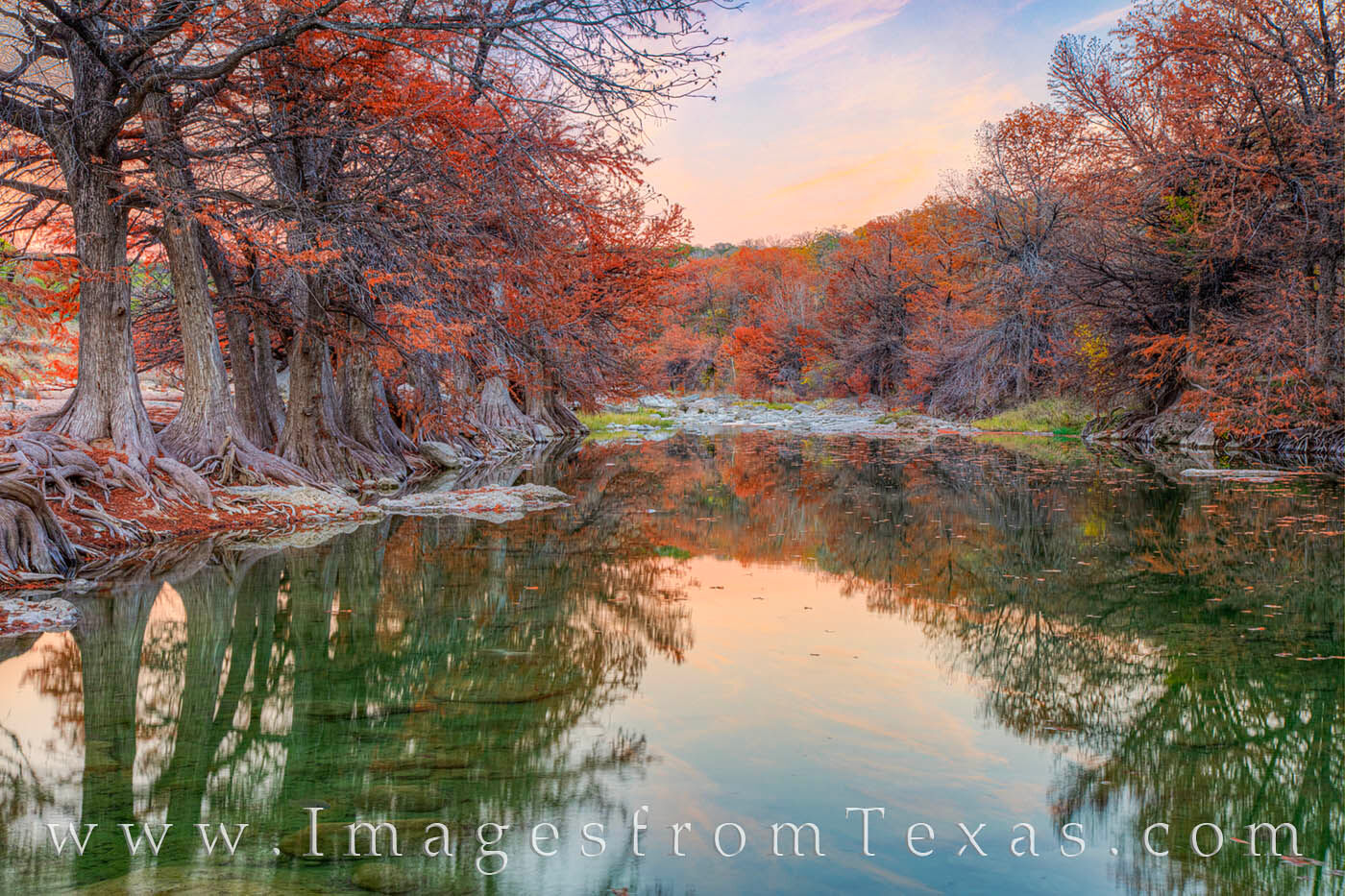 The last light of day hangs over the Pedernales River on a cool Autumn evening. Fall colors adorn the cypress trees resting along...