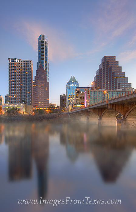 Looking towards downtown Austin, this photograph shows the Congress Bridge as it stretches across Lady Bird Lake. Congress Avenue...