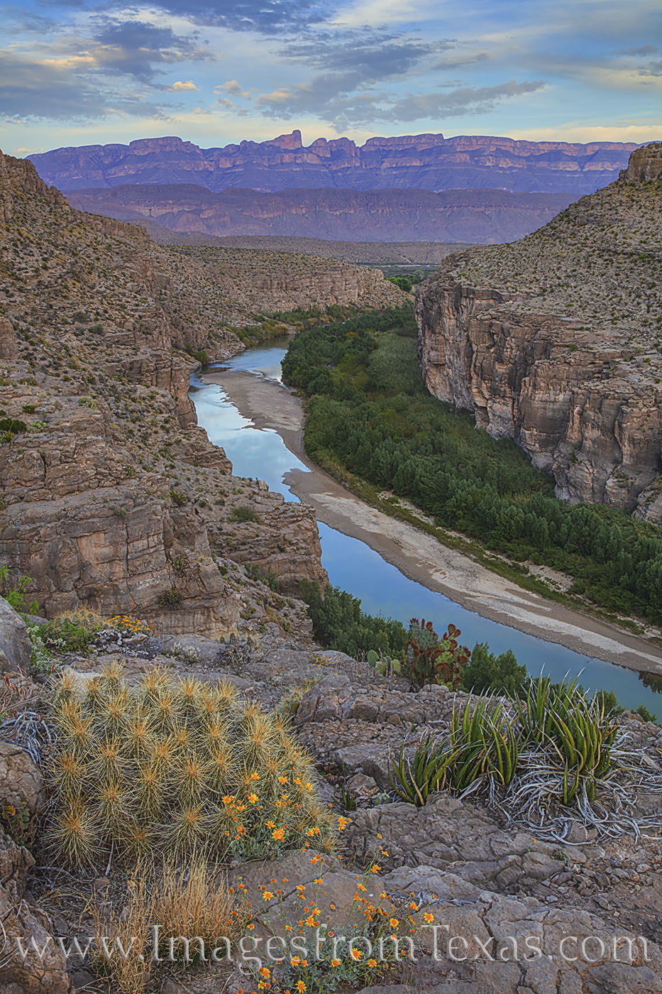 In the soft light of the evening, the Rio Grande flows west through Hot Springs Canyon. In the distance, the Sierra del Carmen...