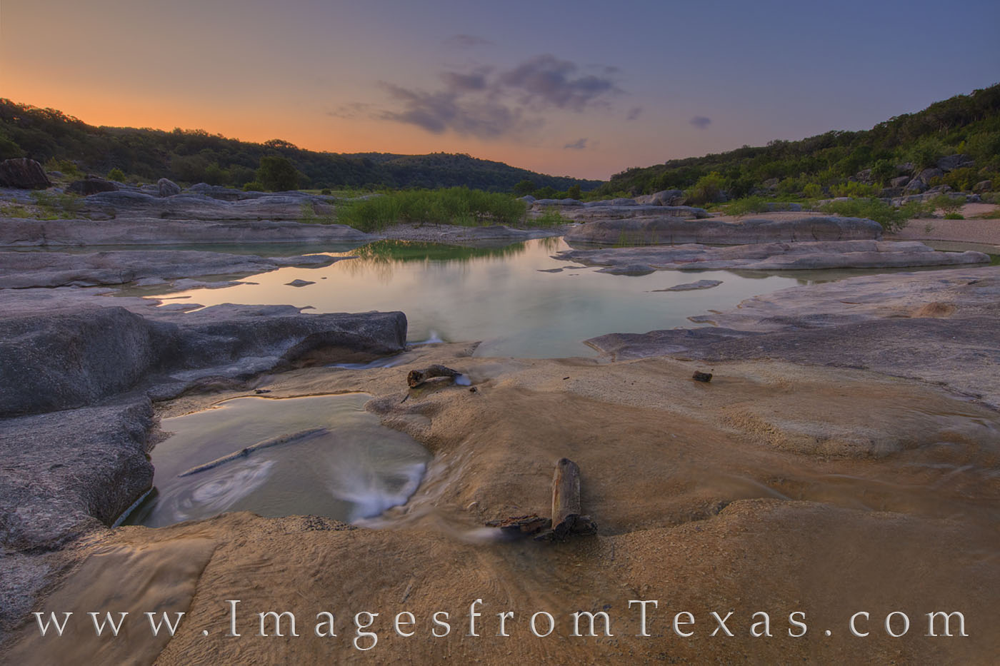 On a quiet August morning along the Pedernales River, low clouds drift by about 20 minutes before sunrise. The water was low -...
