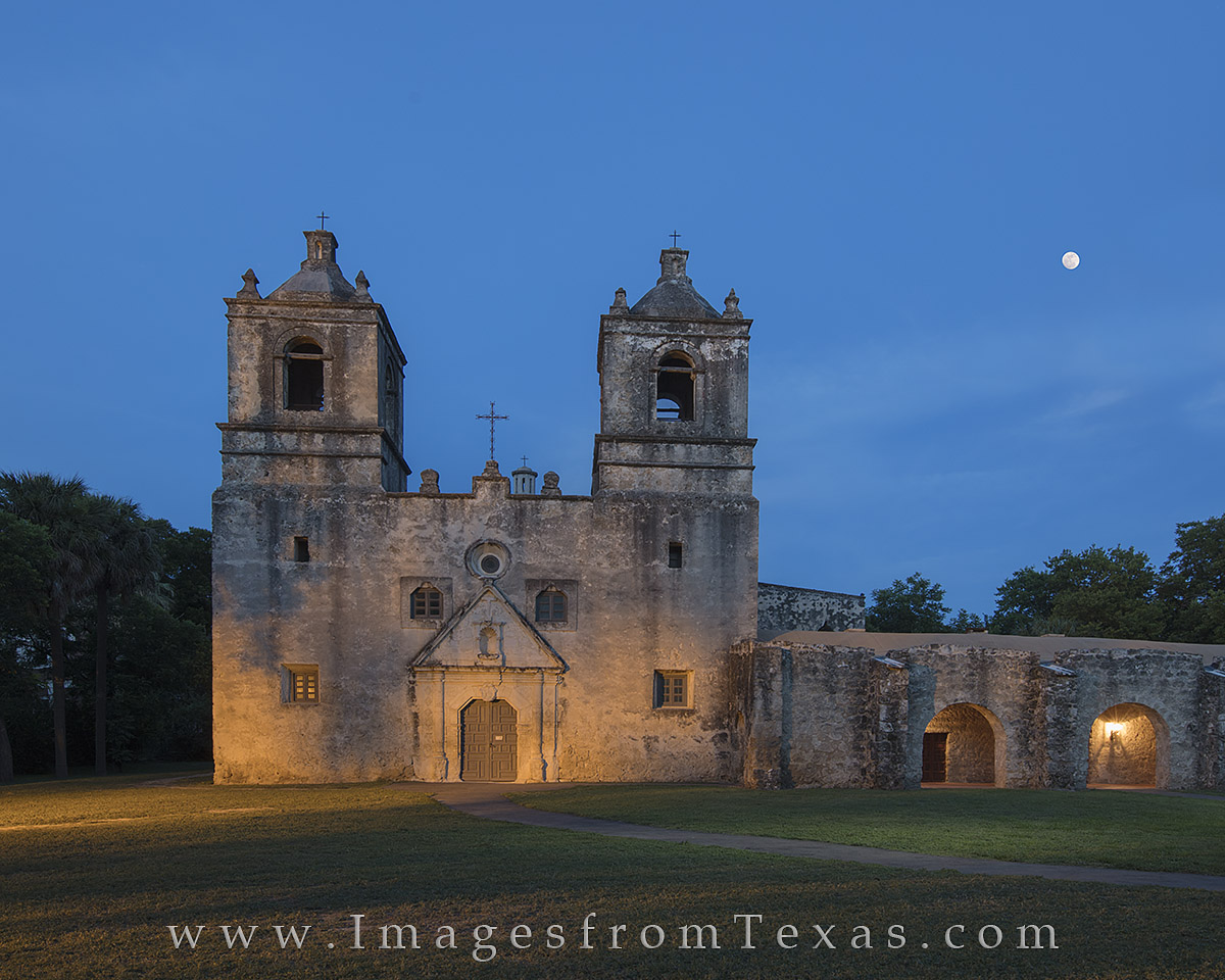 A full moon rises over San Antonio's Mission Concepcion, just south of downtown. As part of the National Historic Park system...