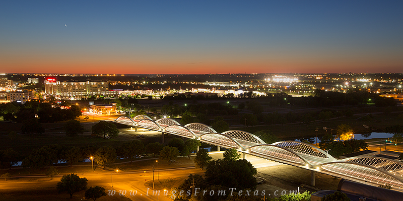 This evening photograph taken in Fort Worth, Texas shows the 7th Street Bridge as a crescent moon descends in the west.