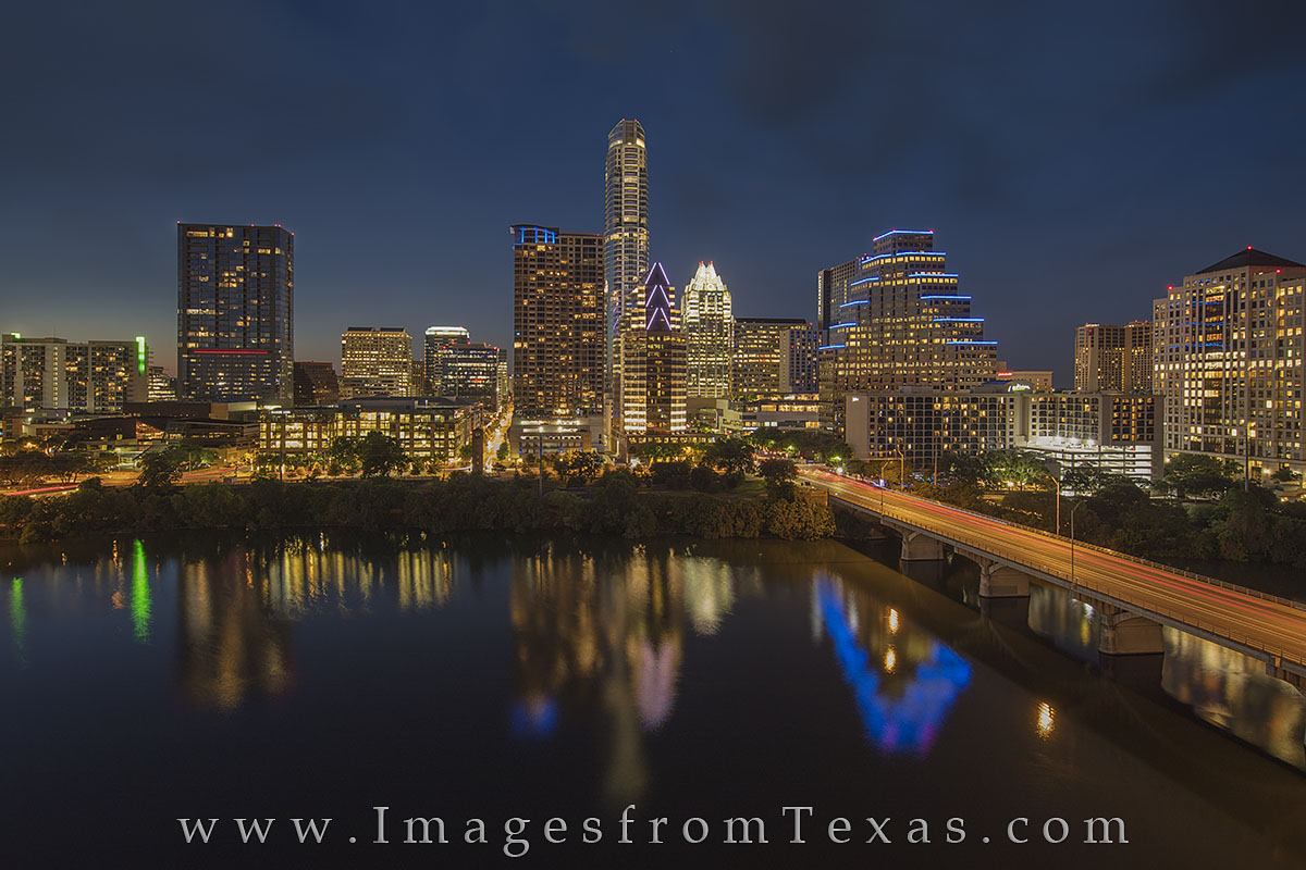 The skyline of Austin, Texas, glows in the evening. This Austin image comes from the top of the Hyatt and shows Congress Bridge...