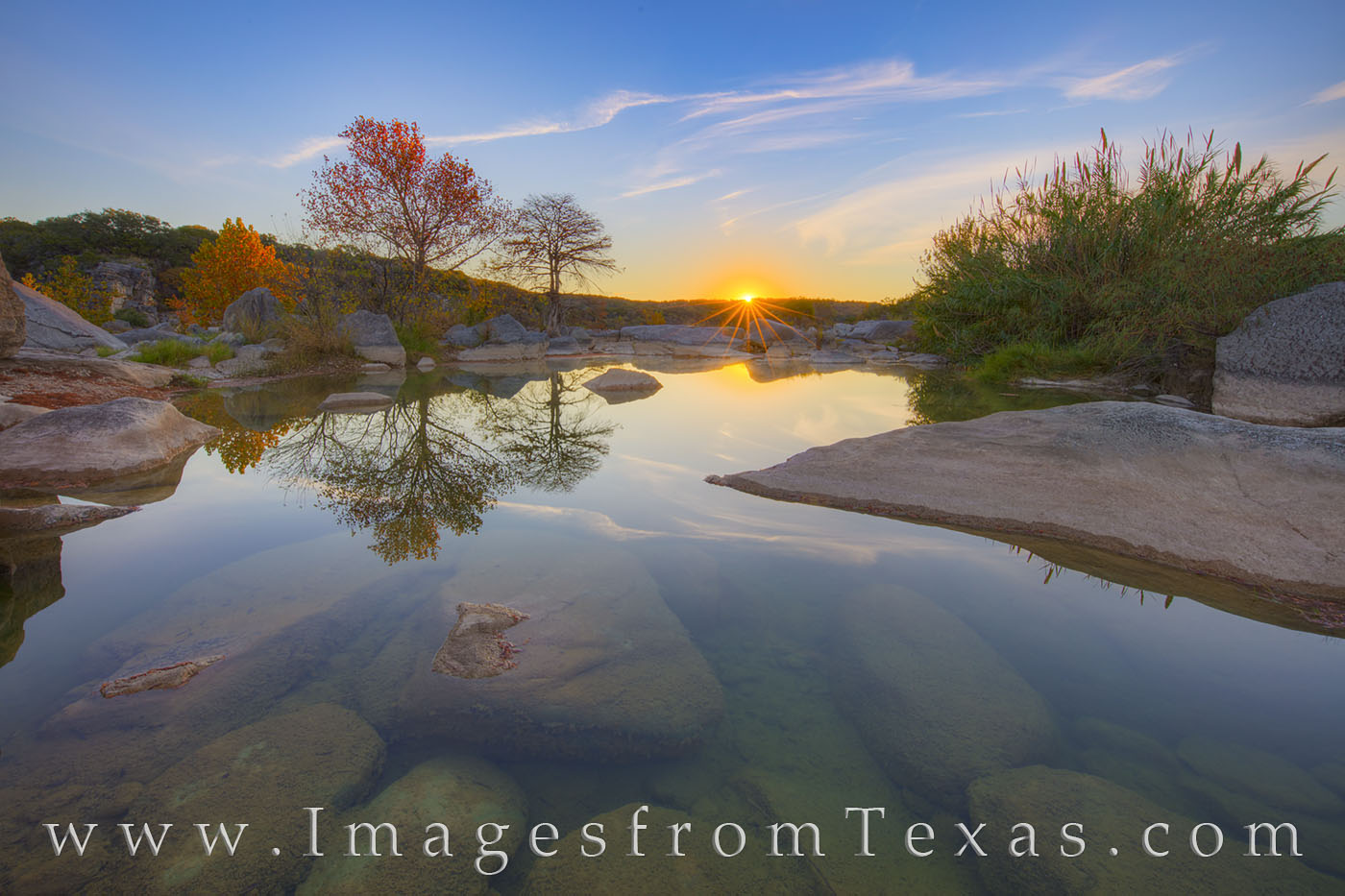 Sunlight glances off the tops of trees along the Pedernales River on a just-above-freezing November morning. The reflections...