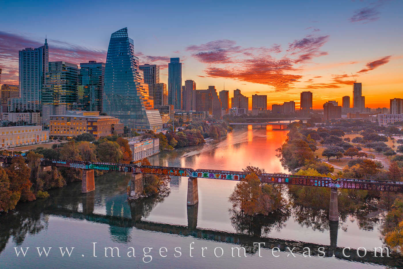 From high above the Pfluger Pedestrian Bridge in Downtown Austin, a beautiful Autumn morning begins another day. Ladybird Lake...