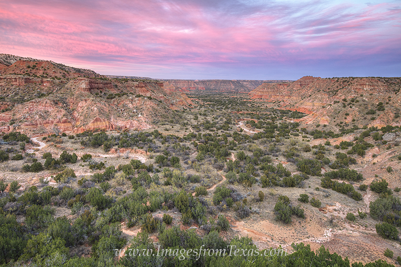 The air had a pink hue as the sun set in the west. From the iconic Lighthouse rock formation in Palo Duro Canyon, this view came...