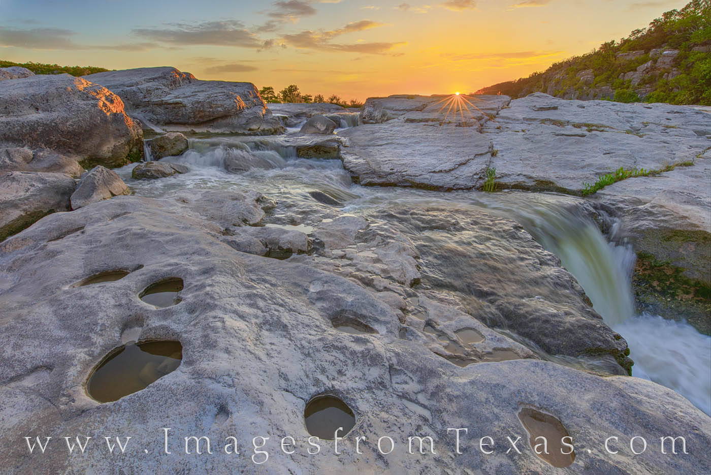 Cool water flows through the limestone rocks along the Pedernales River. Taken on a beautiful June sunset, this photograph shows...