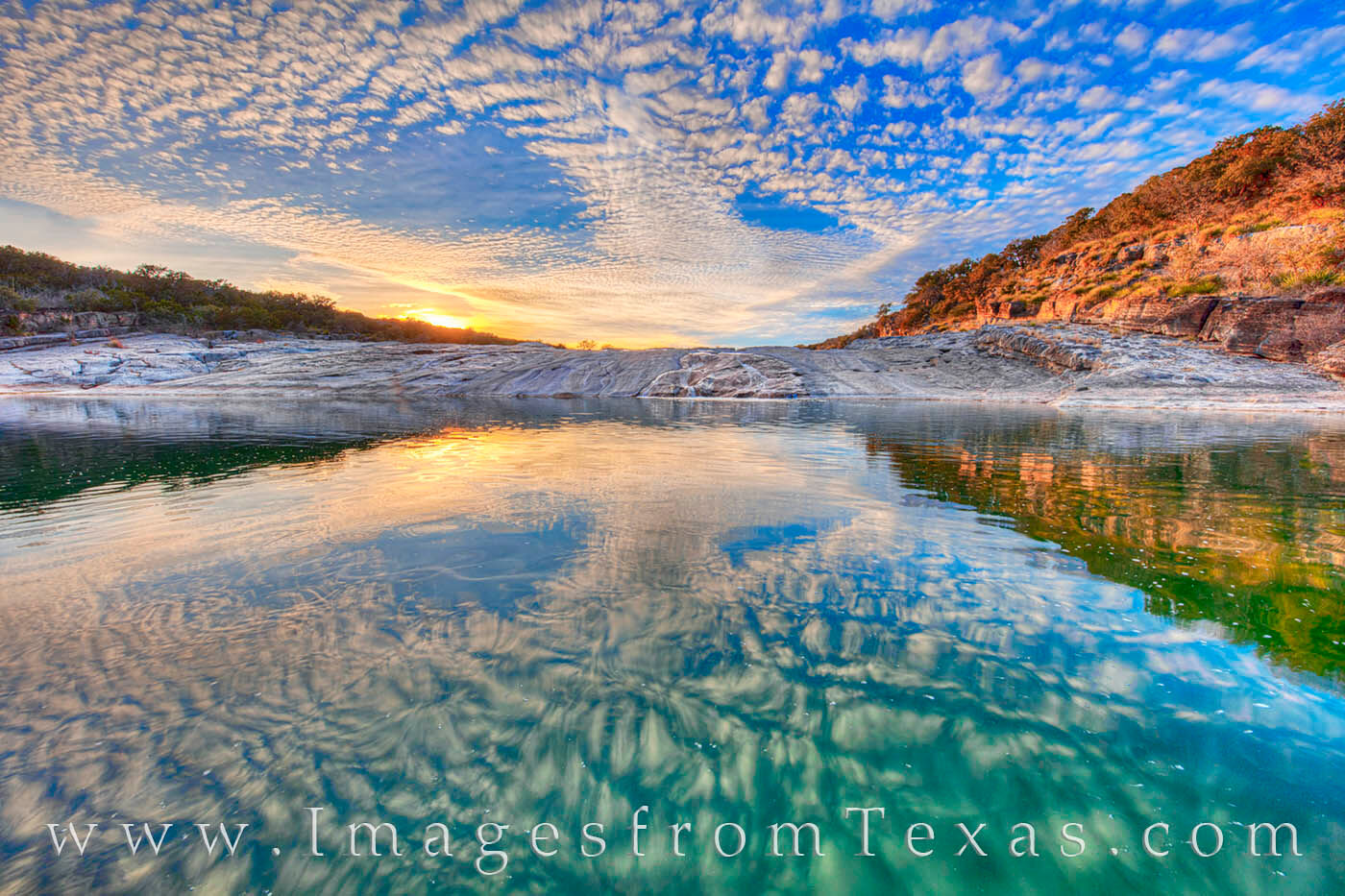 A stunning sunset sky is reflected in a calm pool along the Pedernales River. I loved how the blue and aqua colors blended together...