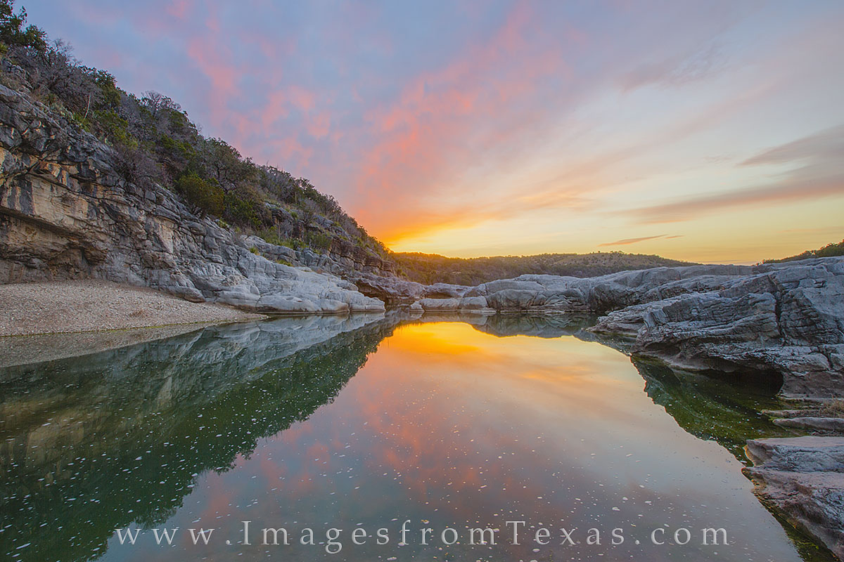 Sunrise comes to the Pedernales River in the Texas Hill Country. Along this stretch of river, pools such as this form, and the...