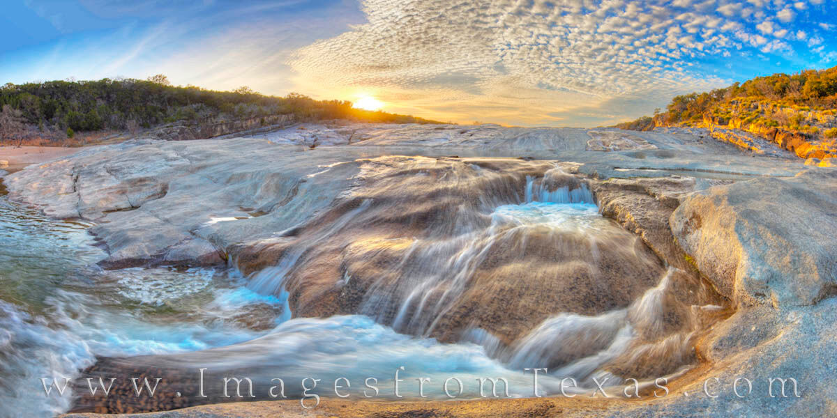 The aqua-clear water of the Pedernales River cascades over smooth limestone rocks on a perfect and cold February sunset. Scenes...