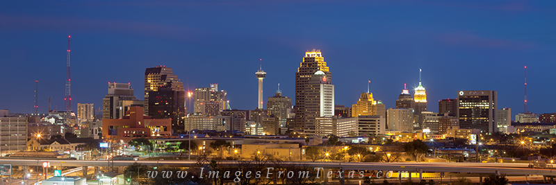 On a warm April evening, downtown San Antonio comes alive underneath the neon lights of the big city. This panorama of thecityscape...
