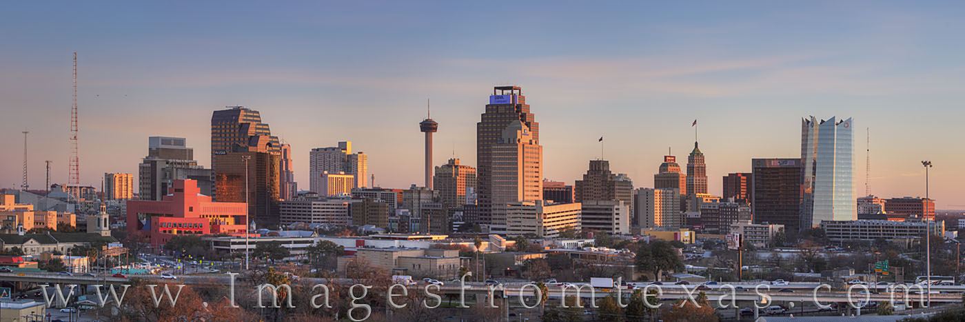 The last light of day spreads warmth across the high rises of downtown San Antonio. The building seemed to glow in orange and...