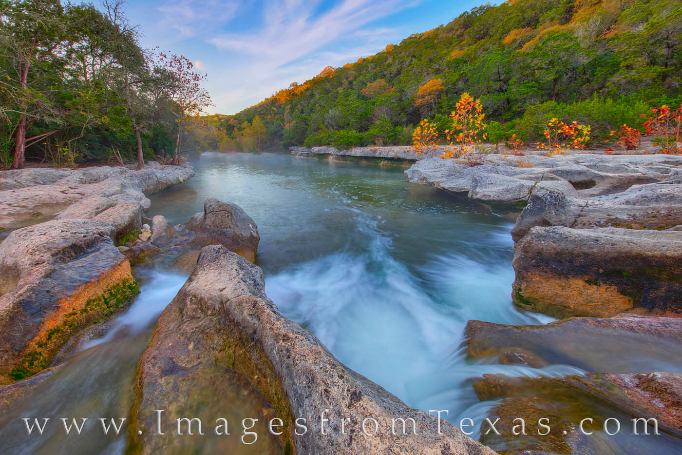 Cold spring water tumbles over the limestone rocks at Sculpture Falls in the Barton Creek Greenbelt on a cold Autumn morning.