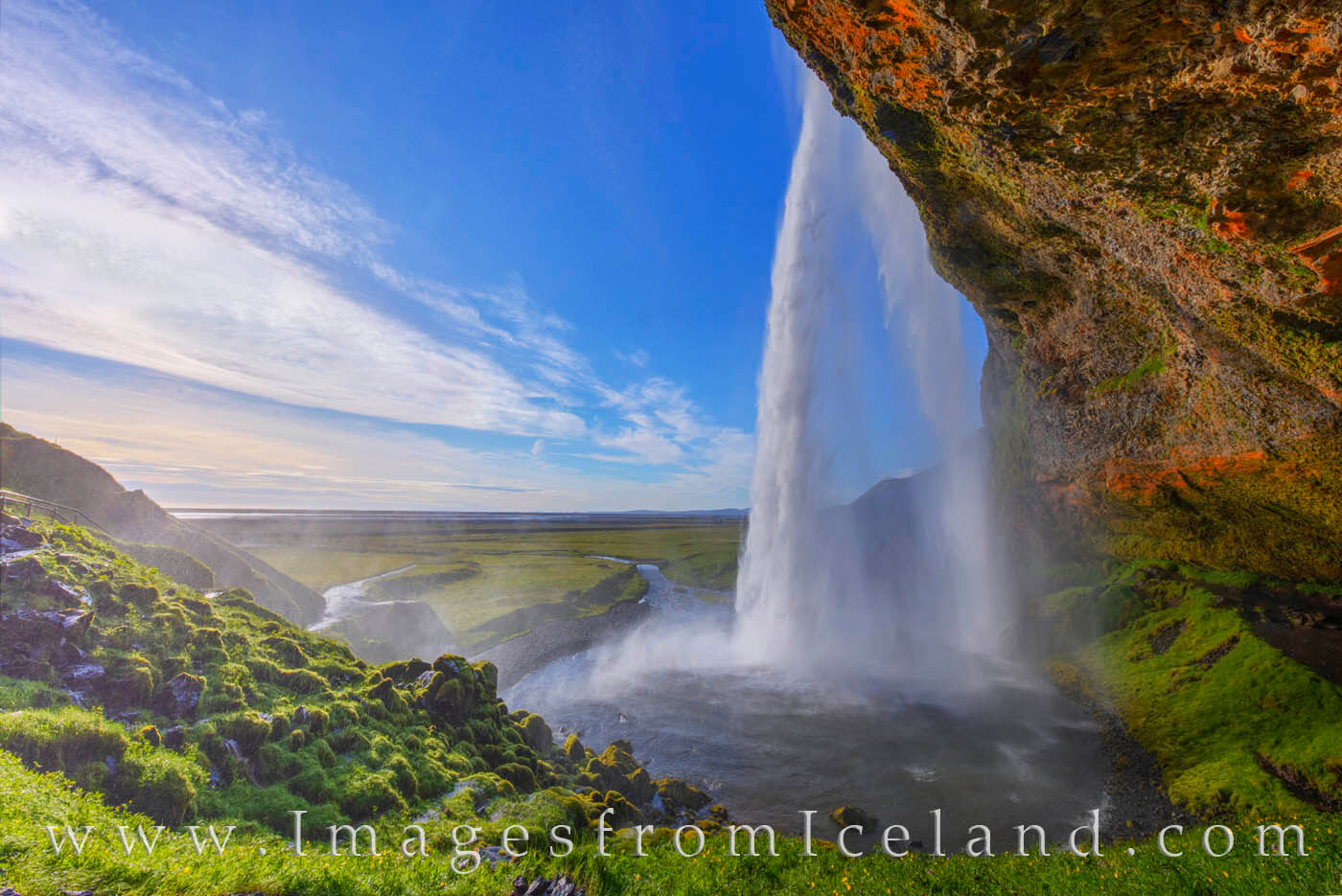 In the late afternoon in south Iceland, Seljalandsfoss flows over the rock walls on its way to the Atlantic Ocean. As one of...