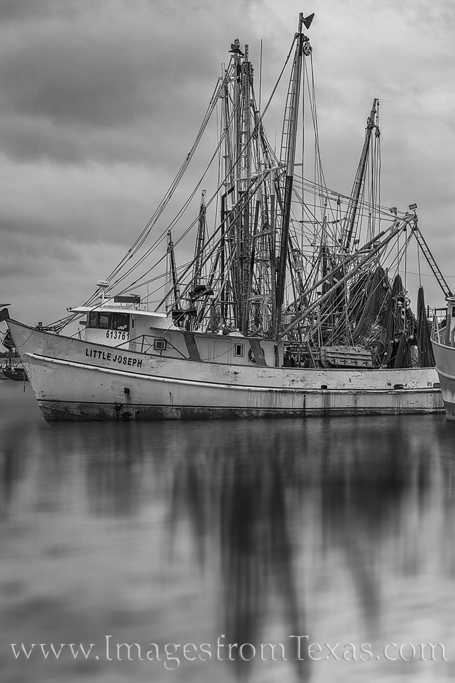 The shrimp boat, the Little Joseph, rests in a harbor in Port Isabel near South Padre Island on a peaceful and quiet morning....
