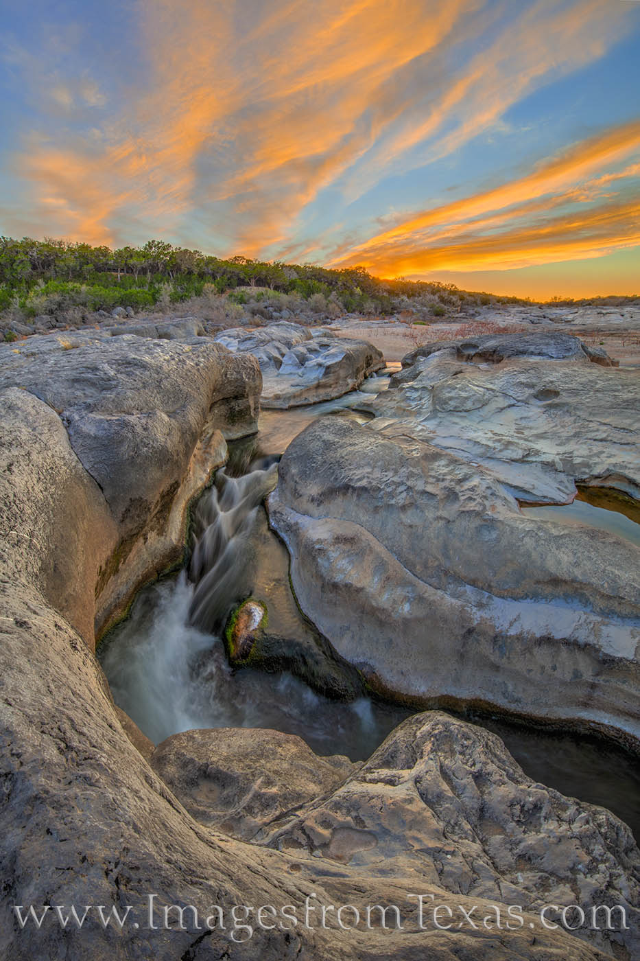 On a lovely spring evening at Pedernales Falls State Park, the colors of the sky light up above the waters below. The river flows...