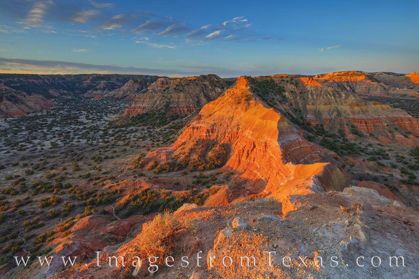 The first light of day shines on the orange rock of Palo Duro Canyon in this view from the summit of Capitol Peak.