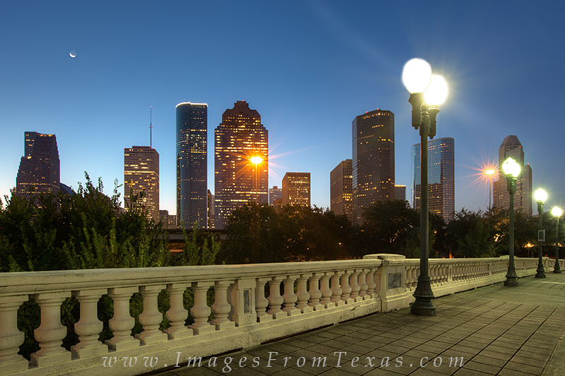 The crescent moon seemed to be leading the sun on this summer morning in Houston, Texas. From the Sabine Street Bridge, the Houston...