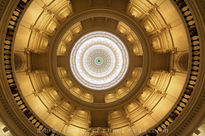 Looking up at the dome from the Rotunda of the State Capitol, visitors are greeted by a Texas Star surrounded by "TEXAS" letters...