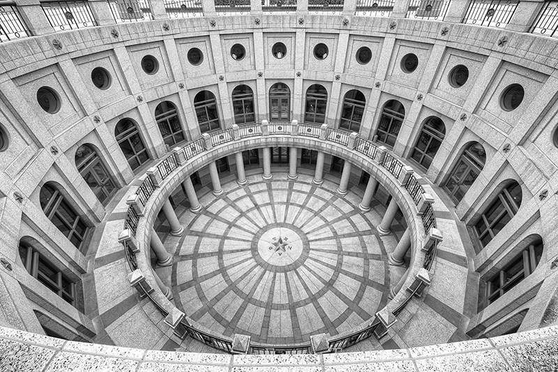 This black and white version of the outdoor rotunda area on the north side of the state capitol of Texas shows off the unique...