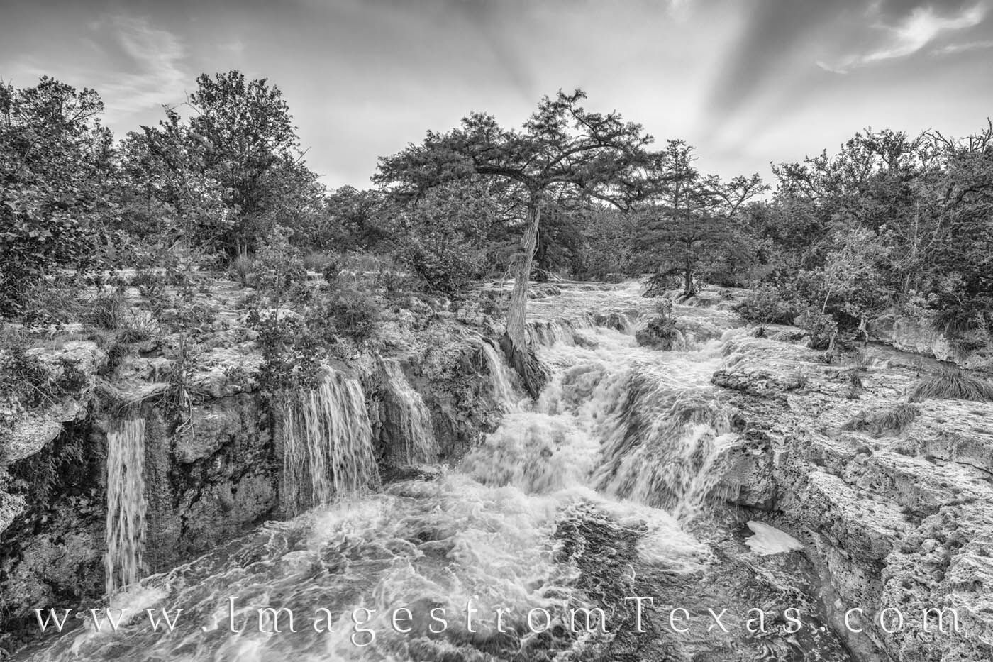 From south of Kendalia, this black and white photograph shows a beautiful waterfall in the hill country after a rain. The sun...