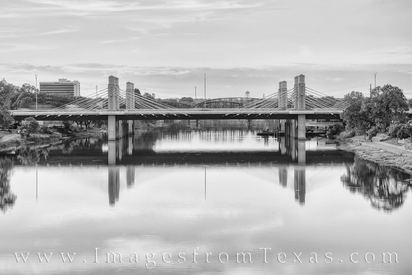 The Twin Bridges in black and white are shown in this photograph from Waco, Texas. The bridges run parallel with I-35 as they...