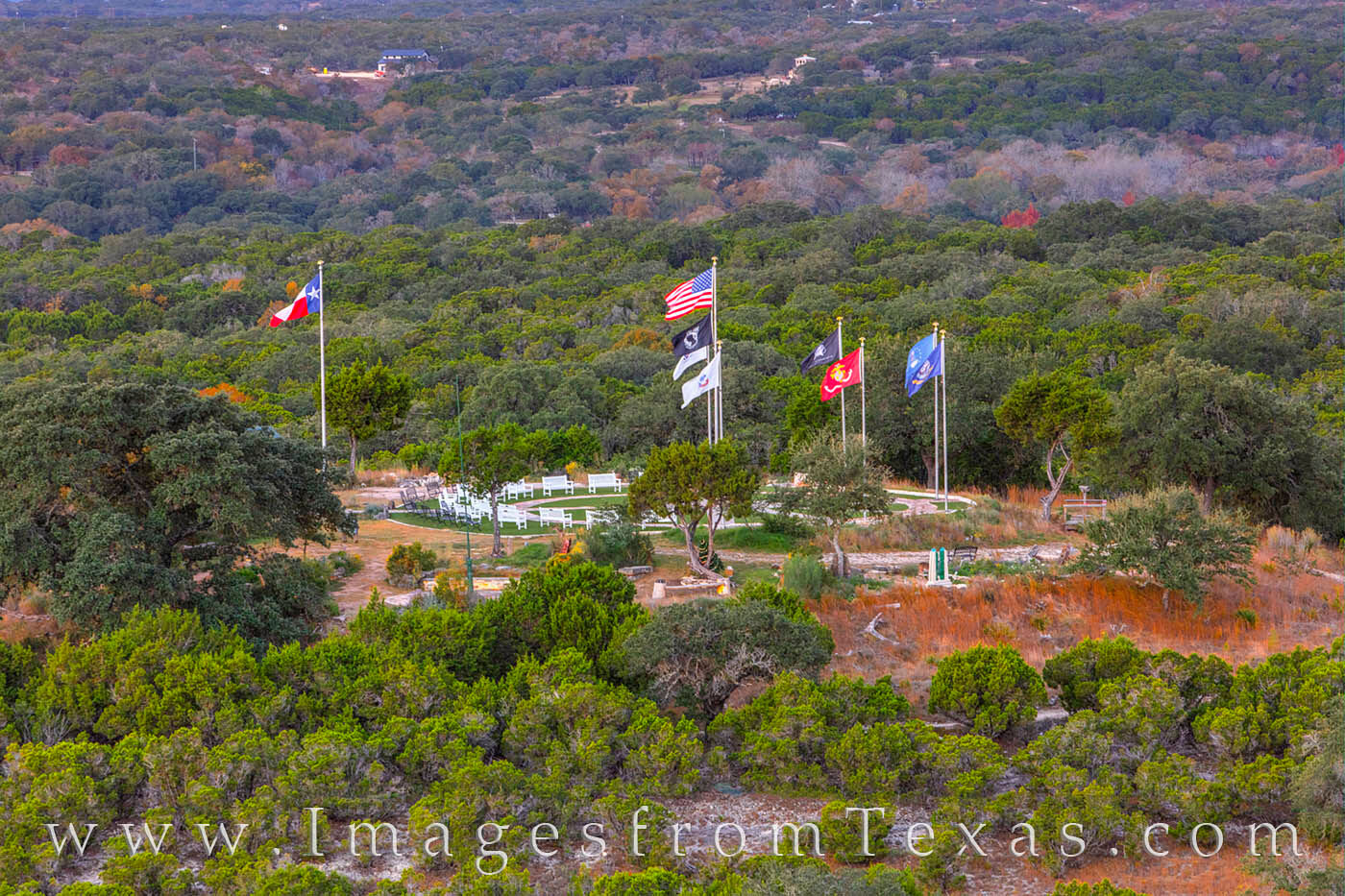 On a cool morning, flags of the US Military forces fly over the Veterans' Memorial in Wimberley, Texas.