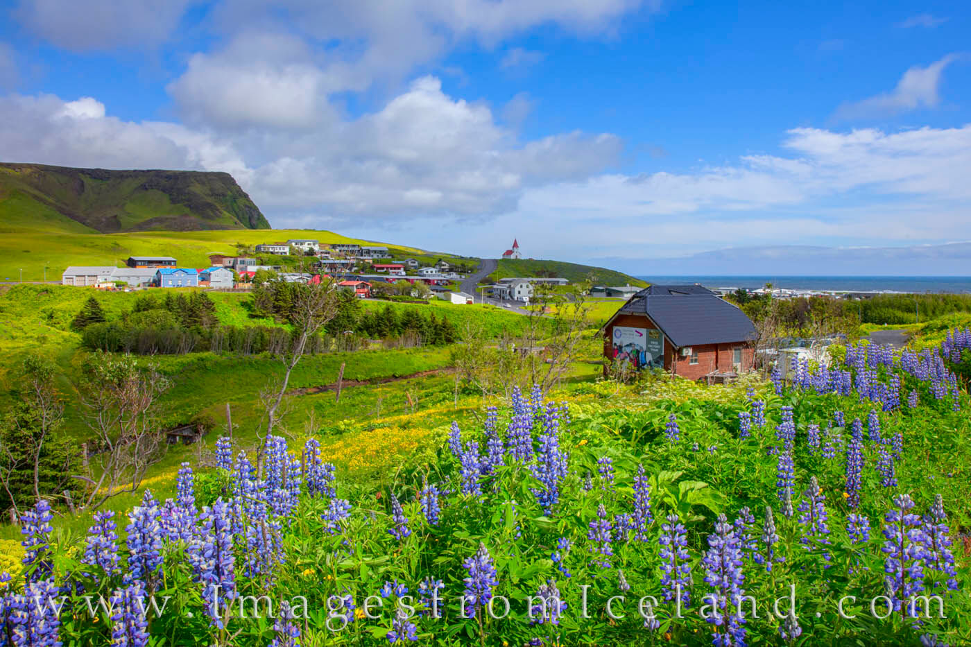 The quaint village of Vik, Iceland, is beautiful on a sunny afternoon.